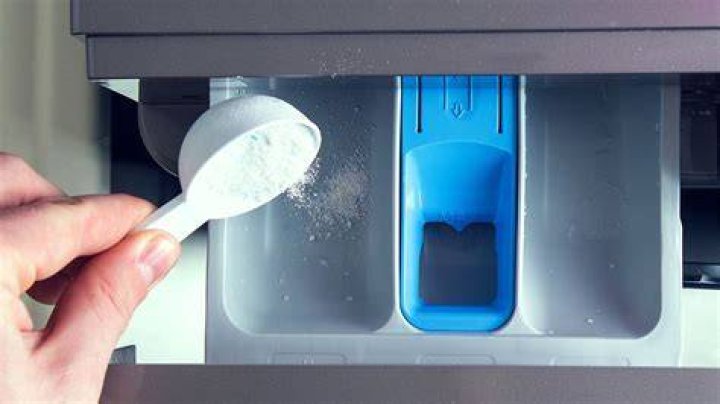 How do I get rid of powder build up in my washing machine drawer?