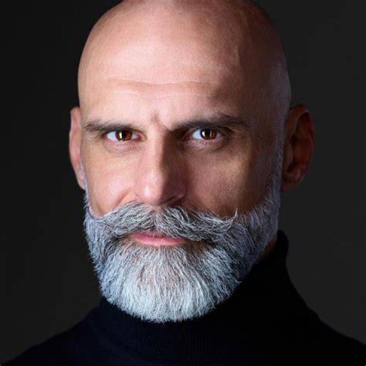 What is the bald man's name in between shades of gray?